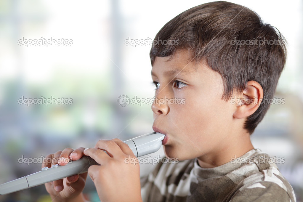 Boy playing recorder Stock Photo by ©dmediapro 12170213