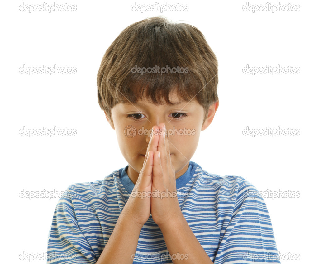 Young boy with hands together