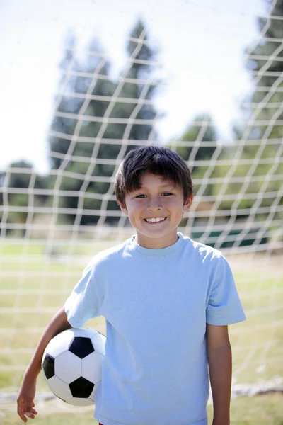 Menino retroiluminado com bola de futebol — Fotografia de Stock