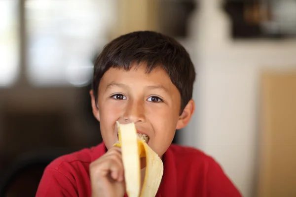 Young boy eating a banana — Stock Photo, Image