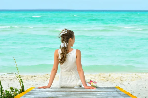 A girl in a white dreams on the pier — Stock Photo, Image