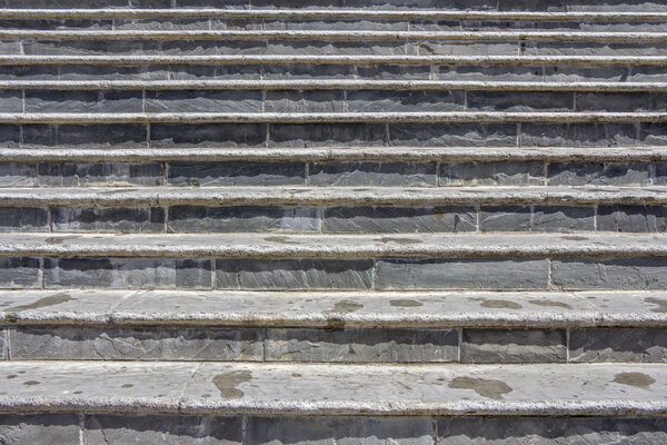 Old damaged stone staircase, up and down, textured background