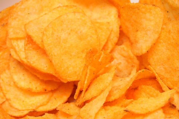 Crunchy golden chips background — Stock Photo, Image