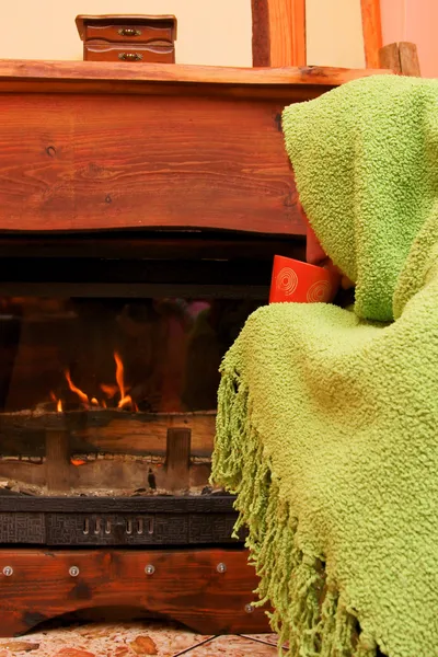 Man warms up by the fire / fireplace — Stock Photo, Image