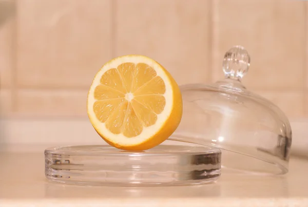 Yellow lemon in kitchen - container — Stock Photo, Image