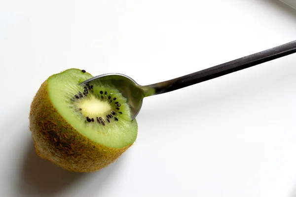 Spoon in kiwi — Stock Photo, Image