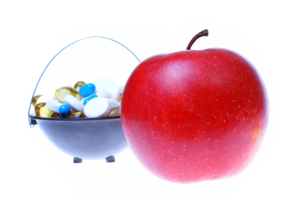 Яблоко и таблетки белый фон — стоковое фото