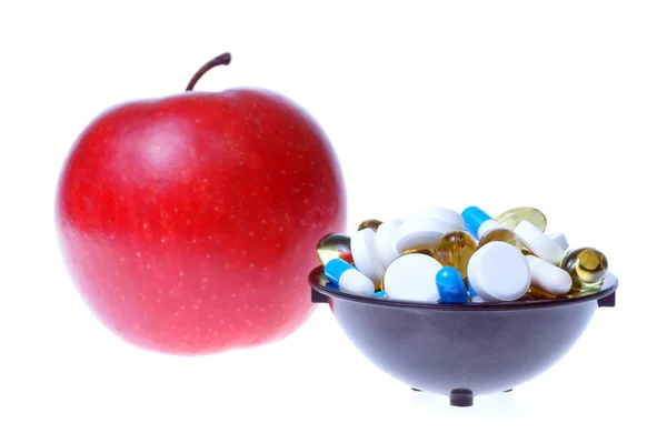 Apple and pills white background — Stock Photo, Image