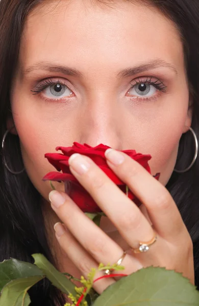 Closeup portrait of attractive young woman holding a red rose — Stock Photo, Image