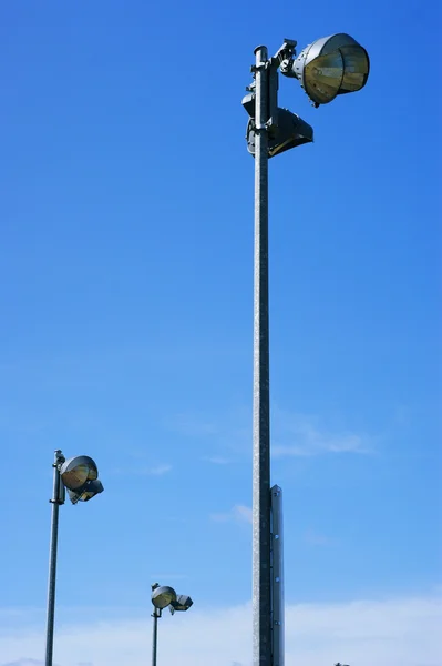 Stadium field lights against the blue sky. — Stock Photo, Image