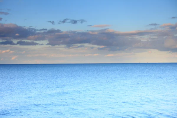 Céu azul nublado partindo para o horizonte mar de superfície azul — Fotografia de Stock