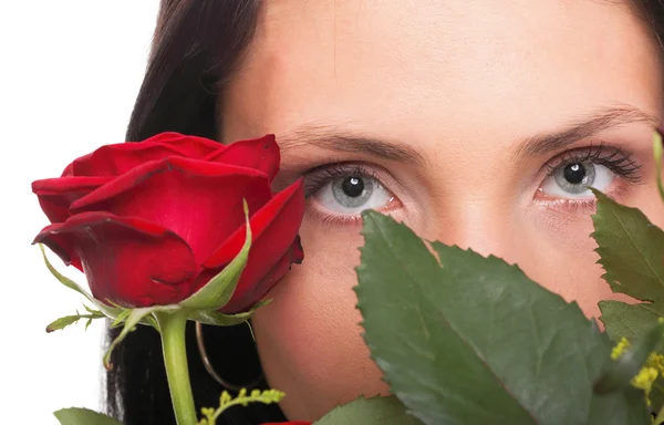 Closeup portrait of attractive young woman holding a red rose — Stock Photo, Image