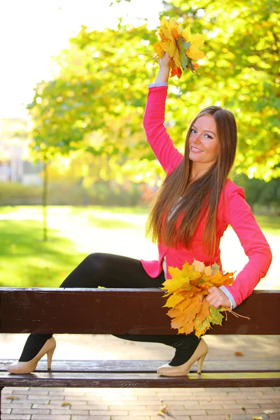 Autumn woman on leafs background — Stock Photo, Image