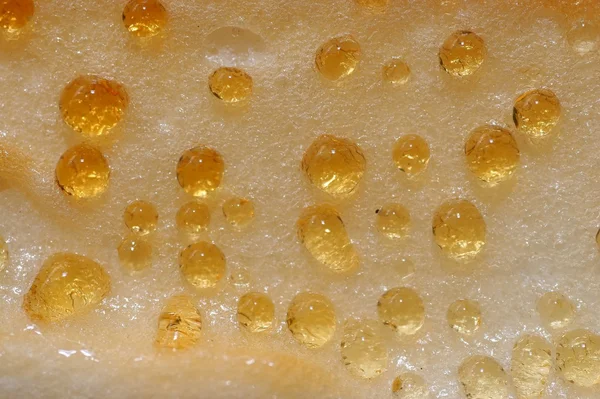Gold macro drops on cheesecake — Stock Photo, Image