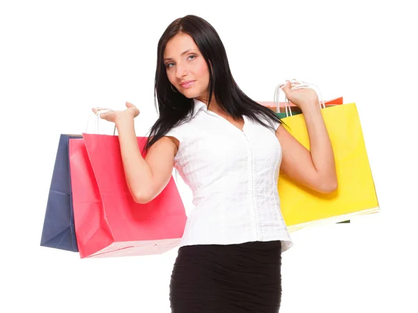 Portrait of young woman carrying shopping bags against white bac Royalty Free Stock Photos
