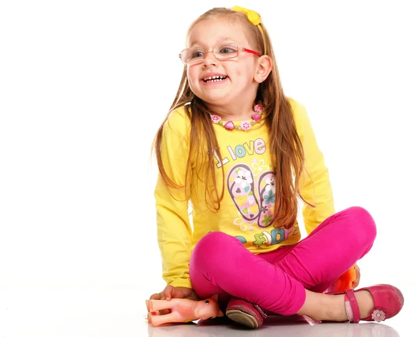 Cheerful little girl glasses funny and toy isolated — Stock Photo, Image