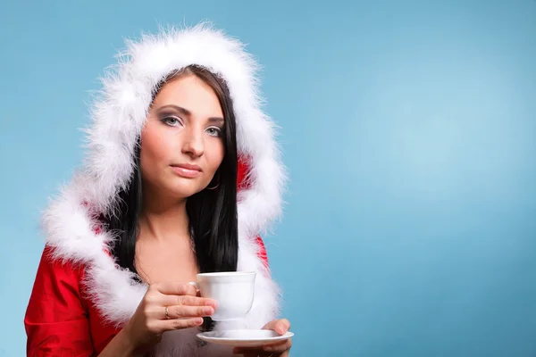Beautiful girl santa claus Girl blowing hot drink — Stock Photo, Image