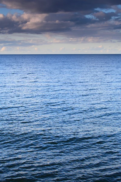 Céu azul nublado partindo para o horizonte mar de superfície azul — Fotografia de Stock