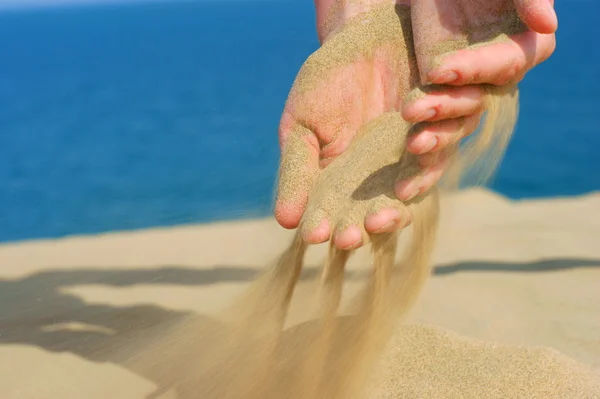 Sand in female hand — Stock Photo, Image