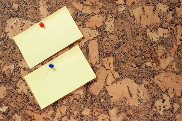 Paper clip and push pin on cork noticeboard — Stock Photo, Image