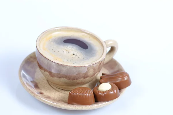 Chocolate pralines cup with black coffee on white — Stock Photo, Image