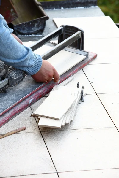 Man cutting tile by cutter — Stock Photo, Image