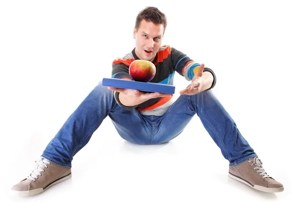 Man holding a book and one red apple full body — Stock Photo, Image