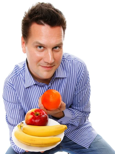 Joven con frutas aisladas — Foto de Stock