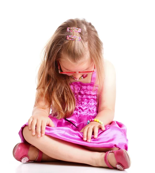 Sad little girl sitting on floor head lowered — Stock Photo, Image