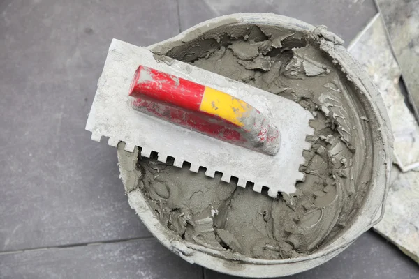 Construction worker is tiling at home tile floor adhesive — Stock Photo, Image