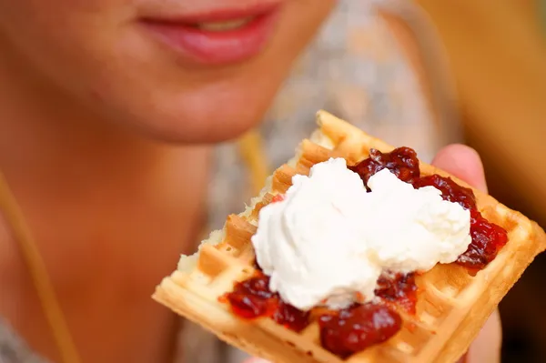 Waffle with cream and strawberry. Plum jam on plate in hand — Stock Photo, Image