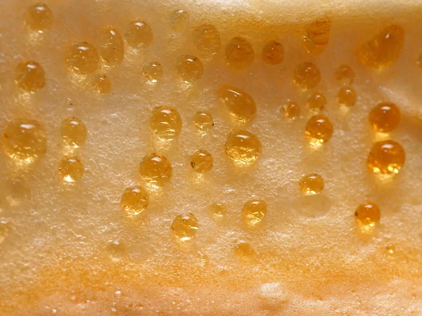 Guld makro droppar på cheesecake — Stockfoto