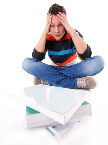 Estudiante universitario cansado con pila de libros aislados —  Fotos de Stock