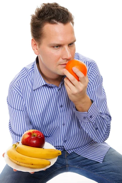 Young man with fruits isolated — Stock Photo, Image