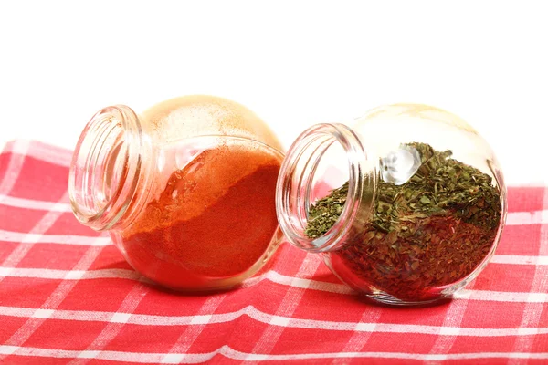 Jars with spices paprika and lovage isolated — Stock Photo, Image