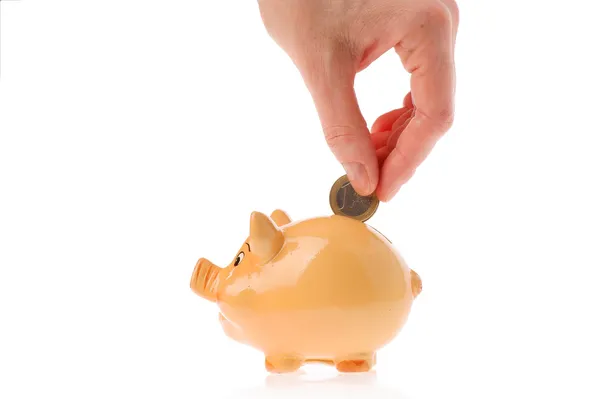 Piggy bank, hand en euro valuta — Stockfoto