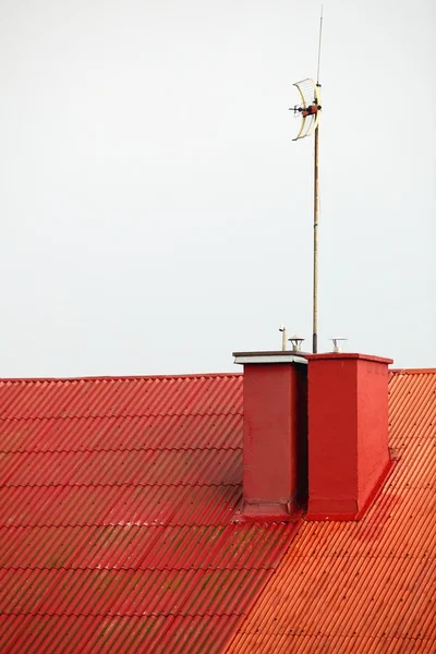 Antenne sur toit rouge ciel blanc — Photo