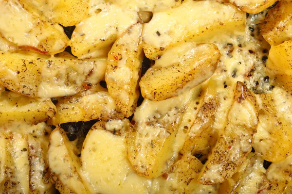 Roasted potatoes with spices and cheese — Stock Photo, Image