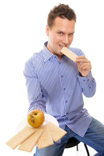 Healthy lifestyle man eating crispbread and apple — Stock Photo, Image