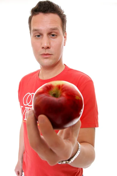 Handsome man in red shirt with apple isolated — Stock Photo, Image