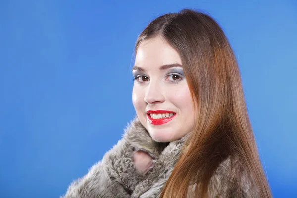 Portrait of young woman in fur blue background — Stock Photo, Image