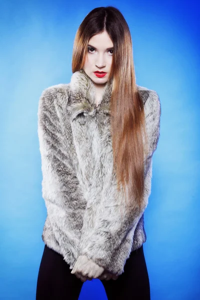 Portrait of young woman in fur blue background — Stock Photo, Image