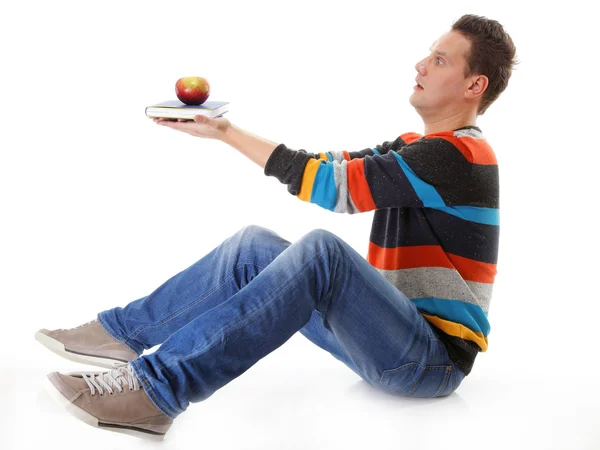 Man holding a book and one red apple full body Stock Image