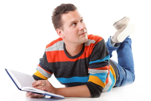 Young man reading a book on the floor isolated — Stock Photo, Image