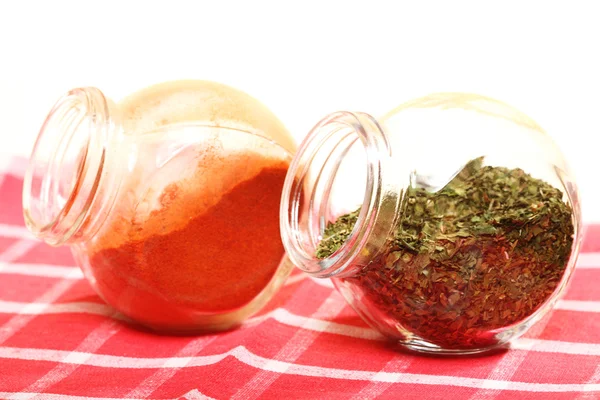 Jars with spices paprika and lovage isolated — Stock Photo, Image