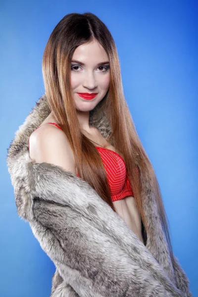 Sexy woman in fur coat and red bra — Stock Photo, Image