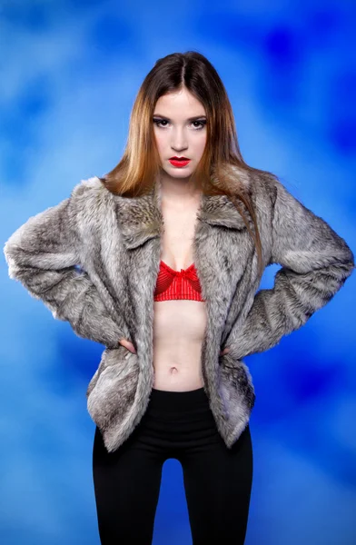 Sexy woman in fur coat and red bra — Stock Photo, Image