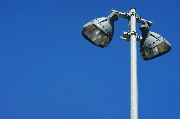 Stadium field lights against the blue sky. — Stock Photo, Image