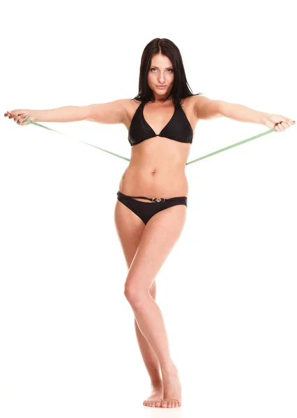 Brunette girl bikini measuring waistline tape — Stock Photo, Image