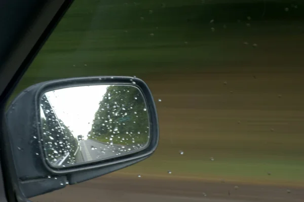 Rain on car in mirror — Stock Photo, Image